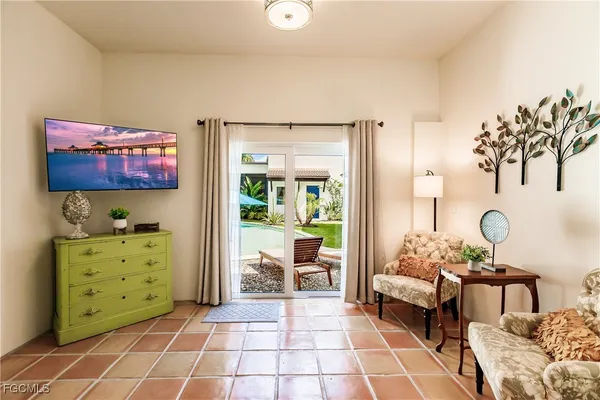 a living room with furniture and a painting on the wall