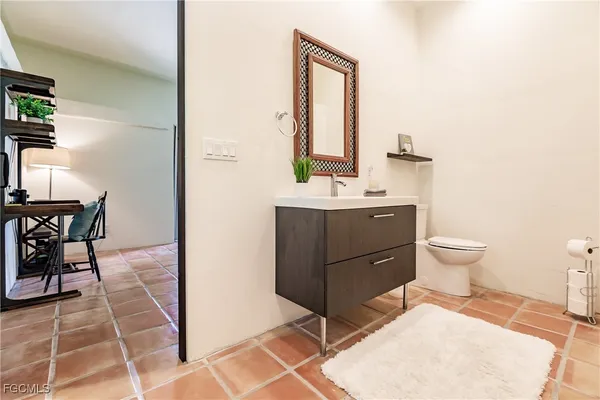 a kitchen with a sink a refrigerator and cabinets