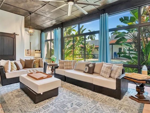a view of a patio with a table chairs and a backyard