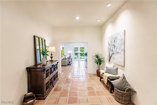 a living room with furniture a flat screen tv and a potted plant
