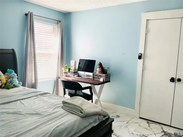 a bedroom with a bed and a table