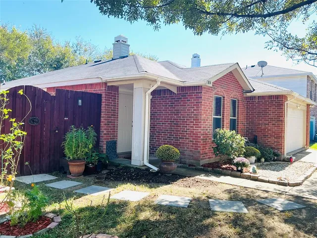 a front view of a house with yard and outdoor seating