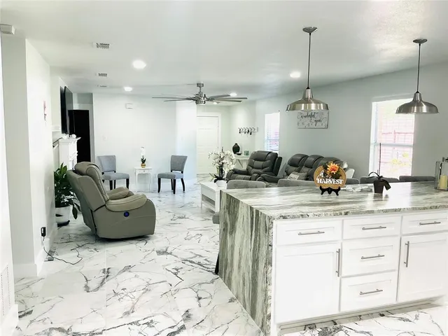 a living room with furniture and a chandelier