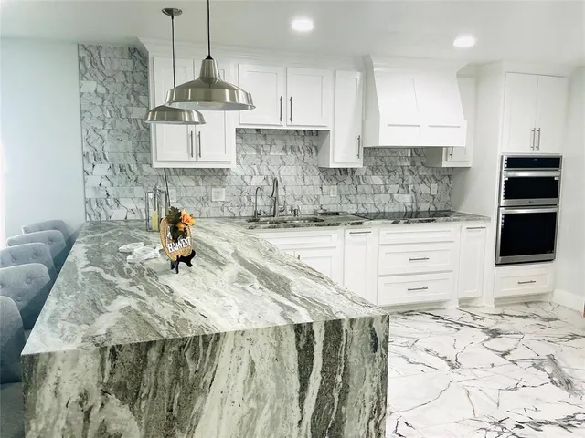 a kitchen with a sink a stove and cabinets