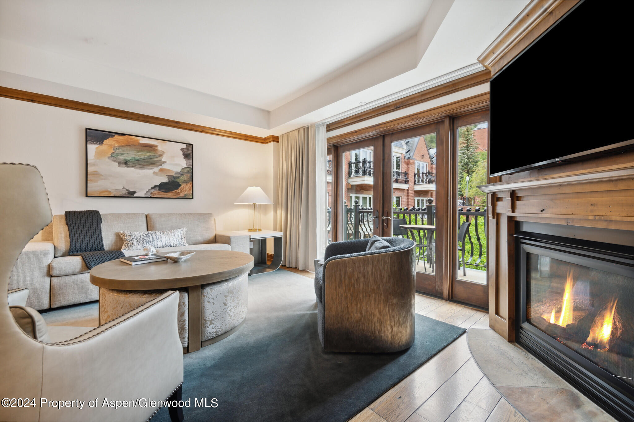 415 East Dean St Unit 22 Week 6 Aspen, CO 81611 - Photo 5 of 25 a living room with furniture a fireplace and a flat screen tv