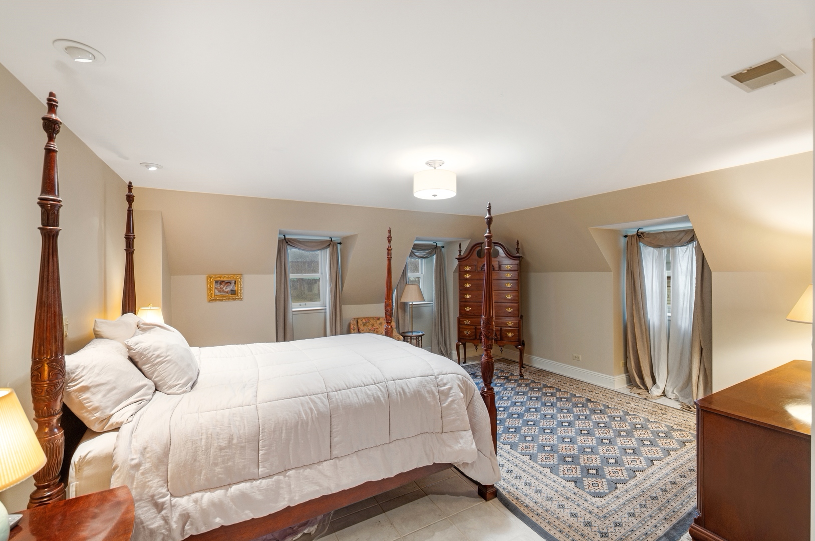 1435 Monroe Avenue River Forest, IL 60305 - Photo 13 of 38 a bedroom with a large bed a rug and chair