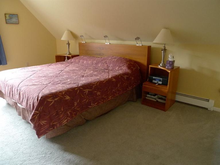 3 Princess Path East Dennis, MA 02660 - Photo 12 of 32 a bedroom with a bed and a lamp on the dresser