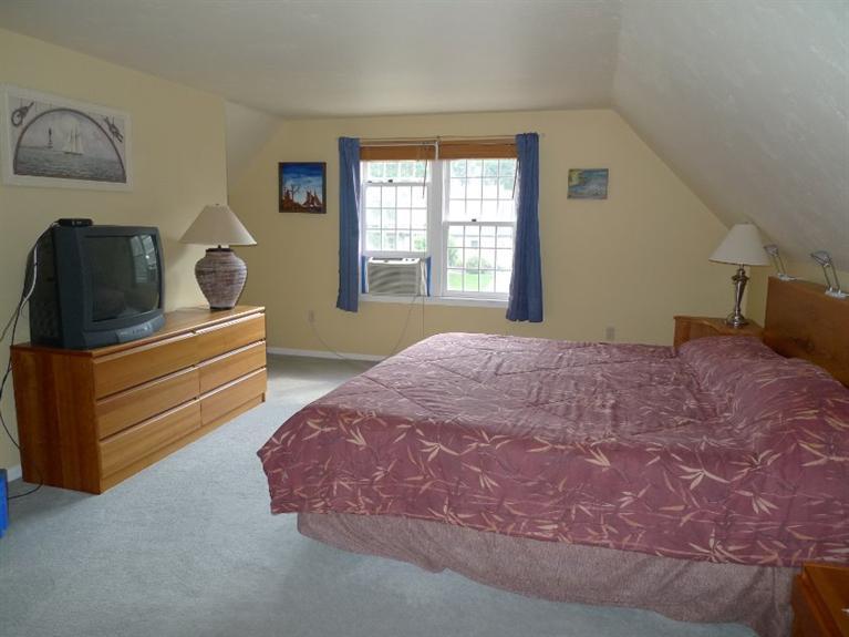 3 Princess Path East Dennis, MA 02660 - Photo 13 of 32 a bedroom with a bed and wooden floor