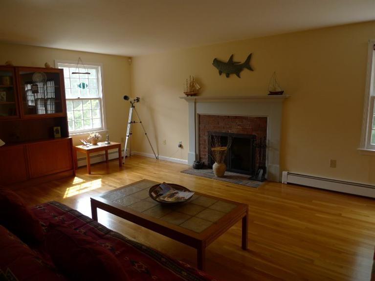 3 Princess Path East Dennis, MA 02660 - Photo 18 of 32 a living room with furniture and a fireplace