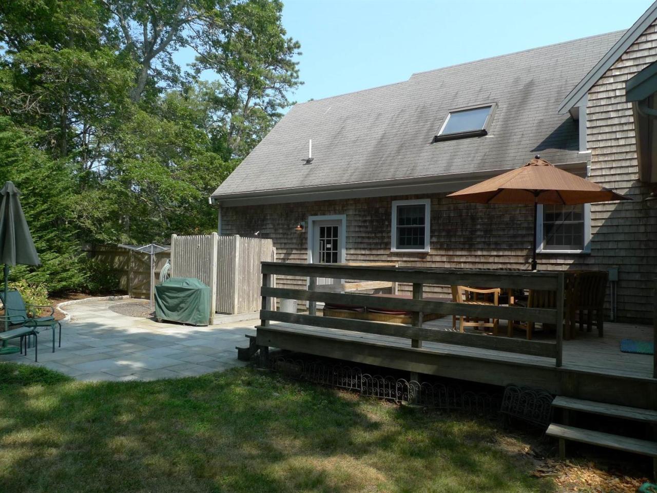 3 Princess Path East Dennis, MA 02660 - Photo 28 of 32 a view of a house with backyard wooden deck and sitting area