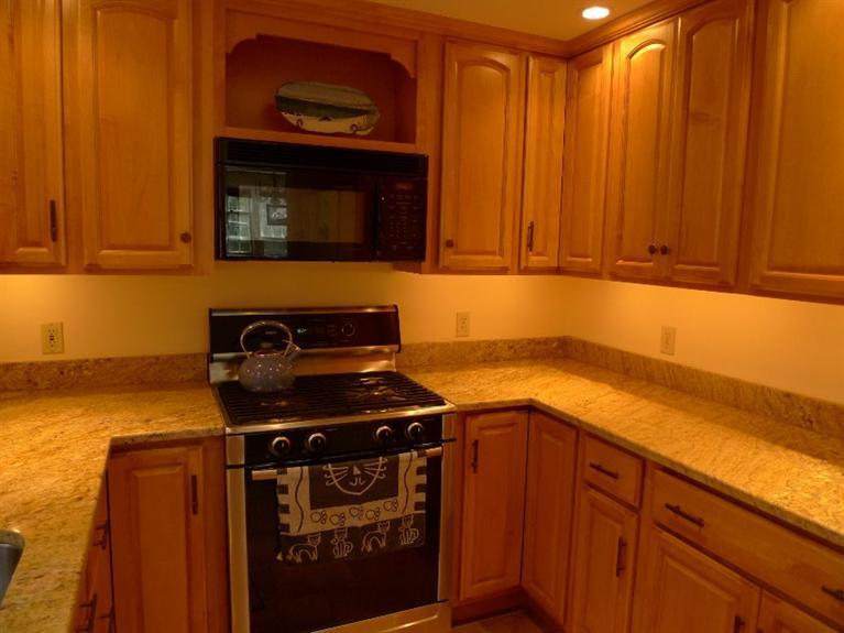 3 Princess Path East Dennis, MA 02660 - Photo 8 of 32 a kitchen with stainless steel appliances granite countertop a stove and a refrigerator