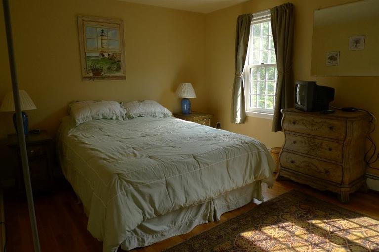 3 Princess Path East Dennis, MA 02660 - Photo 9 of 32 a bedroom with a bed and wooden floor