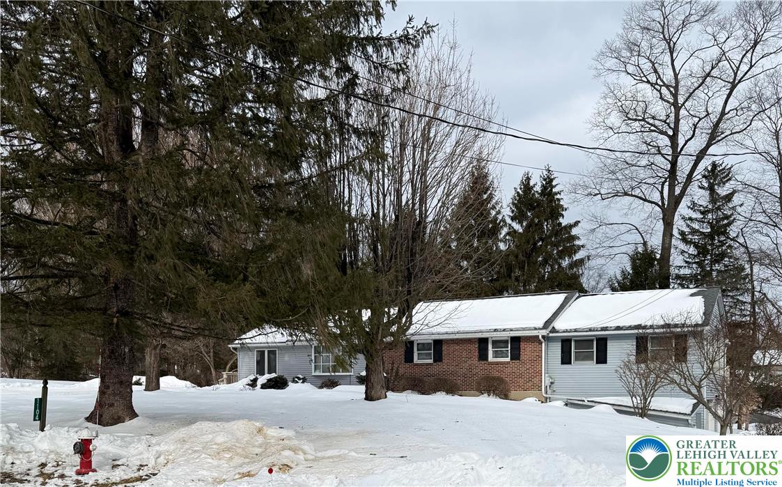 1104 Keller Road Wind Gap, PA 18091 - Photo 1 of 1 a view of a white house with a yard covered in snow