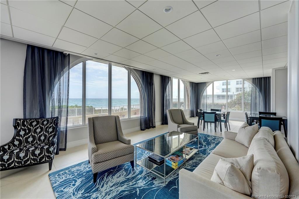 1180 South Ocean Boulevard, Unit 8B Boca Raton, FL 33432 - Photo 16 of 62 a living room with furniture and a large window