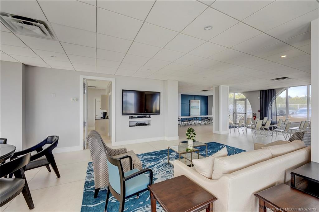 1180 South Ocean Boulevard, Unit 8B Boca Raton, FL 33432 - Photo 18 of 62 a living room with furniture and a flat screen tv
