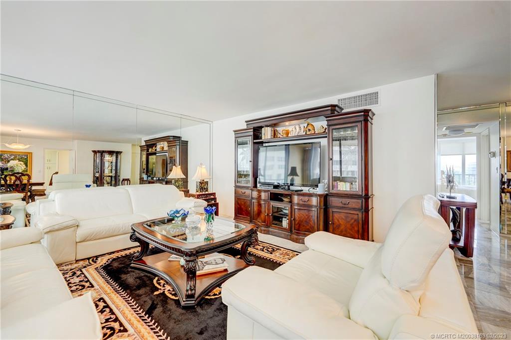 1180 South Ocean Boulevard, Unit 8B Boca Raton, FL 33432 - Photo 24 of 62 a living room with furniture and a flat screen tv