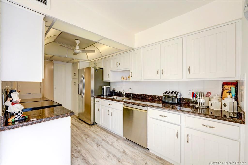 1180 South Ocean Boulevard, Unit 8B Boca Raton, FL 33432 - Photo 35 of 62 a kitchen with cabinets and appliances