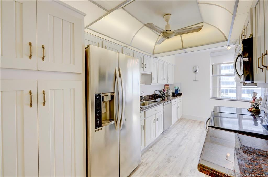 1180 South Ocean Boulevard, Unit 8B Boca Raton, FL 33432 - Photo 38 of 62 a kitchen with stainless steel appliances a refrigerator and a sink