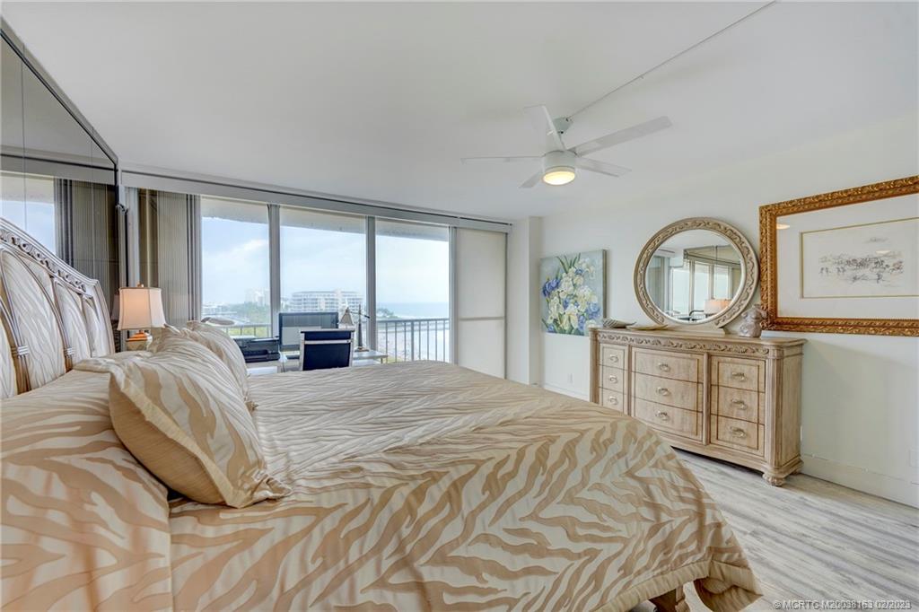 1180 South Ocean Boulevard, Unit 8B Boca Raton, FL 33432 - Photo 44 of 62 a bedroom with a large bed and a dresser