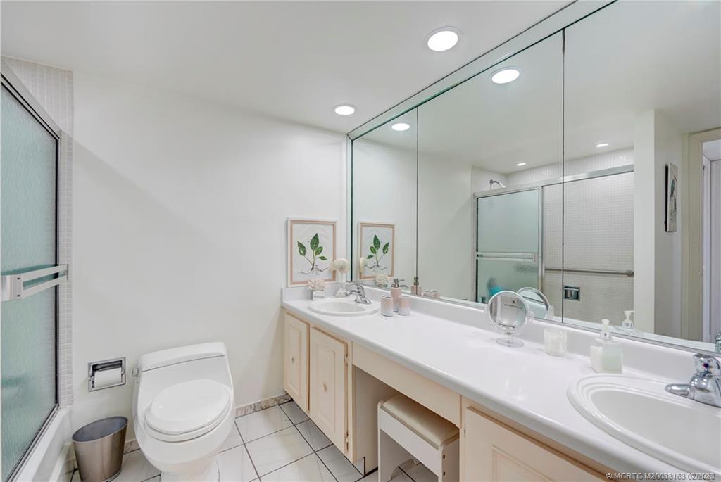 1180 South Ocean Boulevard, Unit 8B Boca Raton, FL 33432 - Photo 45 of 62 a bathroom with a double vanity sink mirror and toilet