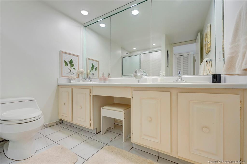 1180 South Ocean Boulevard, Unit 8B Boca Raton, FL 33432 - Photo 46 of 62 a bathroom with a sink toilet and a mirror