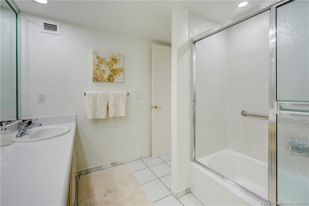 1180 South Ocean Boulevard, Unit 8B Boca Raton, FL 33432 - Photo 47 of 62 a bathroom with a shower and a sink