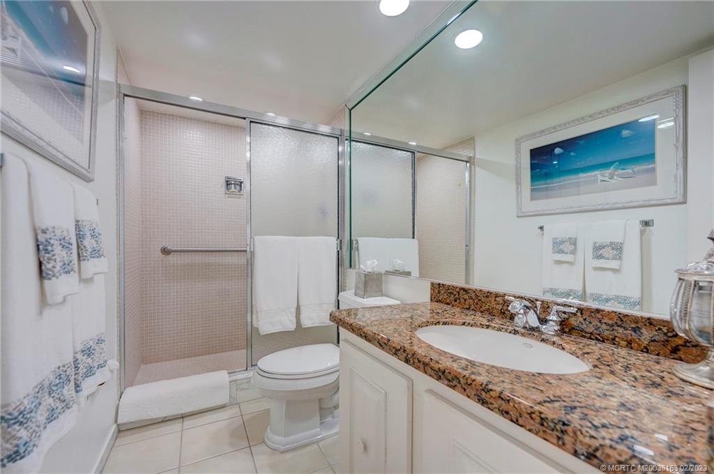 1180 South Ocean Boulevard, Unit 8B Boca Raton, FL 33432 - Photo 49 of 62 a bathroom with a granite countertop sink toilet and shower