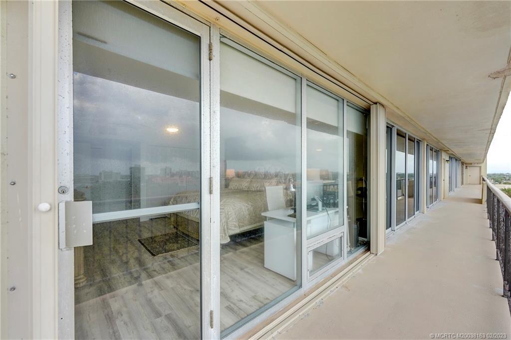 1180 South Ocean Boulevard, Unit 8B Boca Raton, FL 33432 - Photo 57 of 62 a bathroom with a glass shower door and mirror