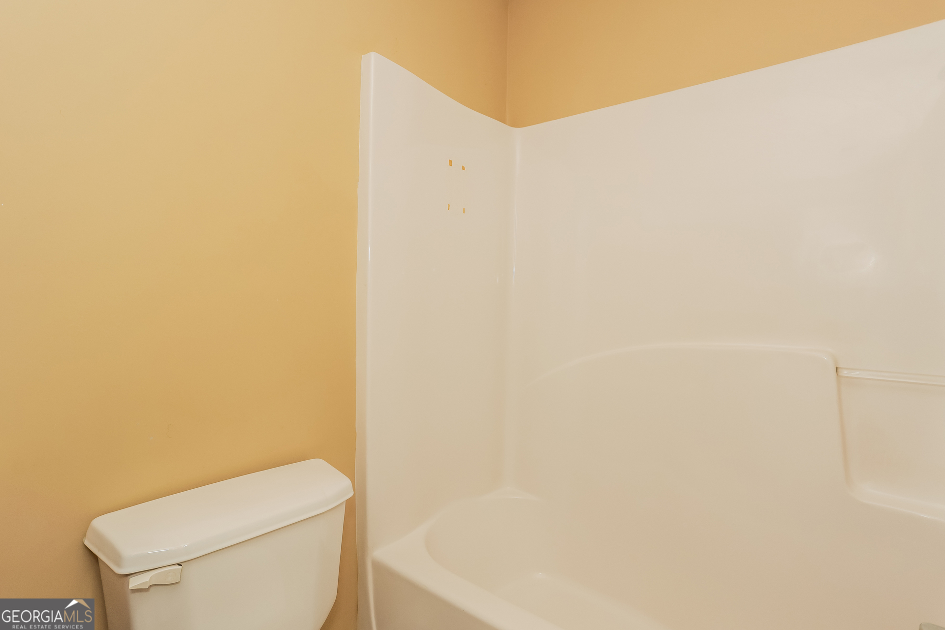 5002 Serenity Point Lane Villa Rica, GA 30180 - Photo 12 of 17 a white toilet sitting next to a white wall