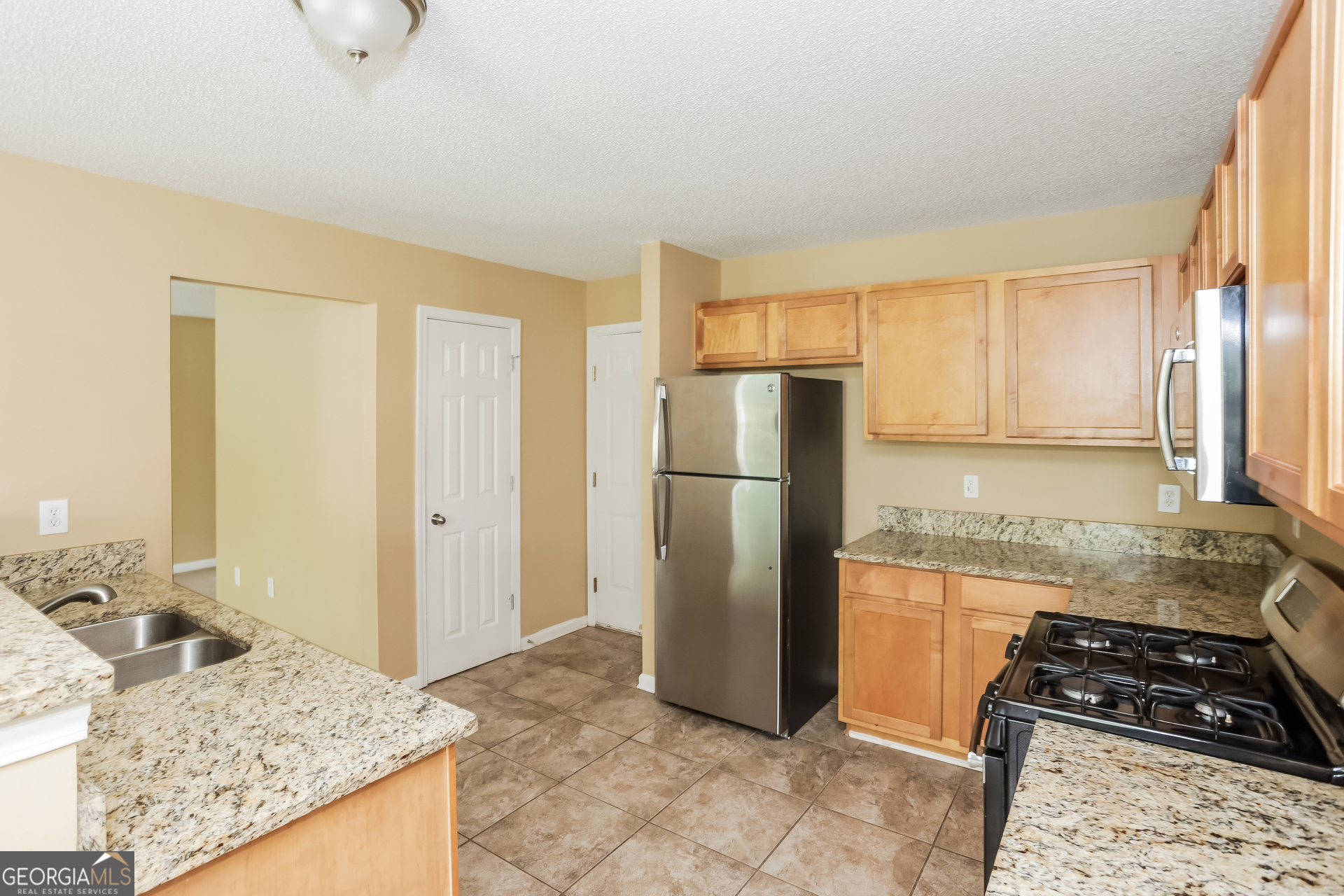 5002 Serenity Point Lane Villa Rica, GA 30180 - Photo 5 of 17 a kitchen with a refrigerator a stove and a sink