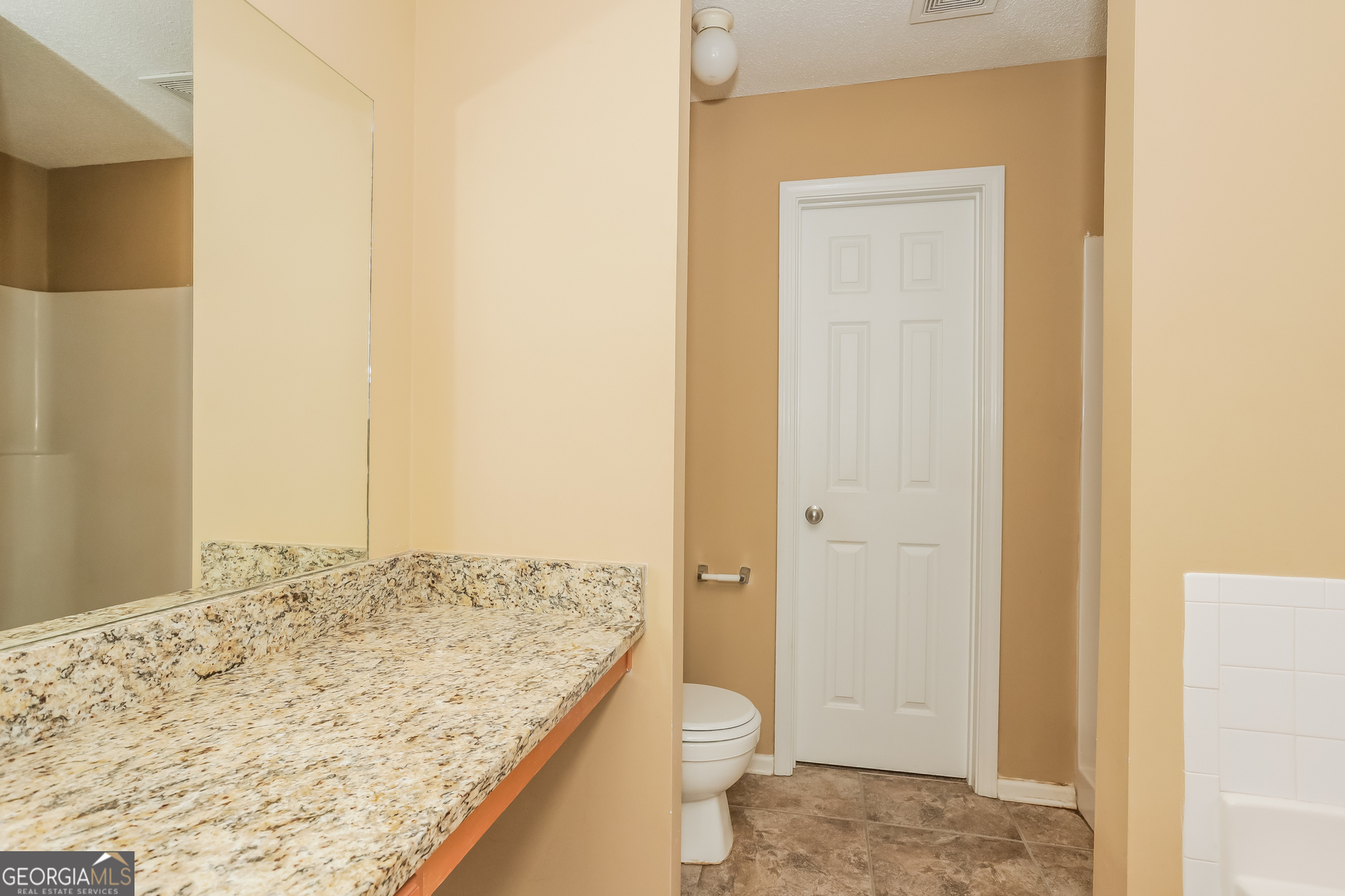 5002 Serenity Point Lane Villa Rica, GA 30180 - Photo 8 of 17 a bathroom with a granite countertop sink and a toilet