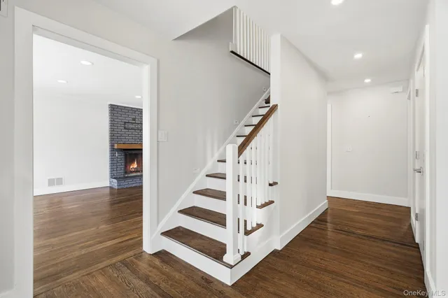 a view of entryway with wooden floor and stairs