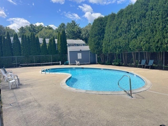 59 Seabury, Unit 59 Hampton, NH 03842 - Photo 3 of 25 a swimming pool with outdoor seating and yard