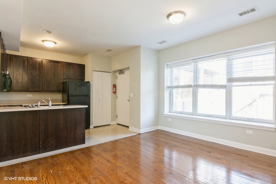 6853 South Ridgeland Avenue, Unit 402 Chicago, IL 60649 - Photo 3 of 6 a view of kitchen with refrigerator cabinets and furniture