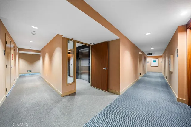 a view of a hallway with wooden floor and closet