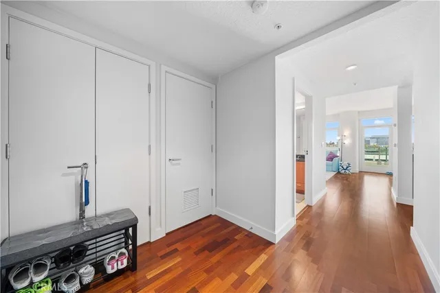 a view of a room with wooden floor and a bathroom