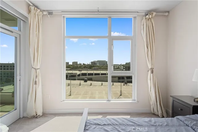 a view of a living room with a floor to ceiling window and entryway