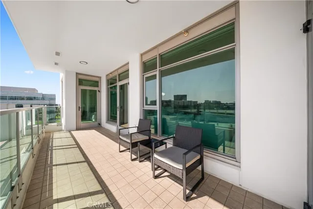 a view of a patio with a table and chairs and potted plants