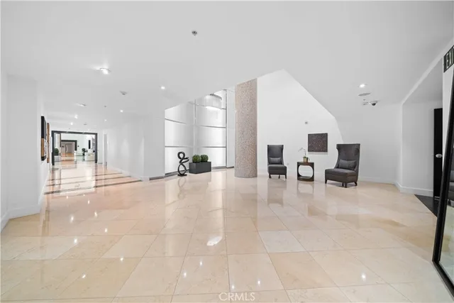a view of a hallway with wooden floor and closet