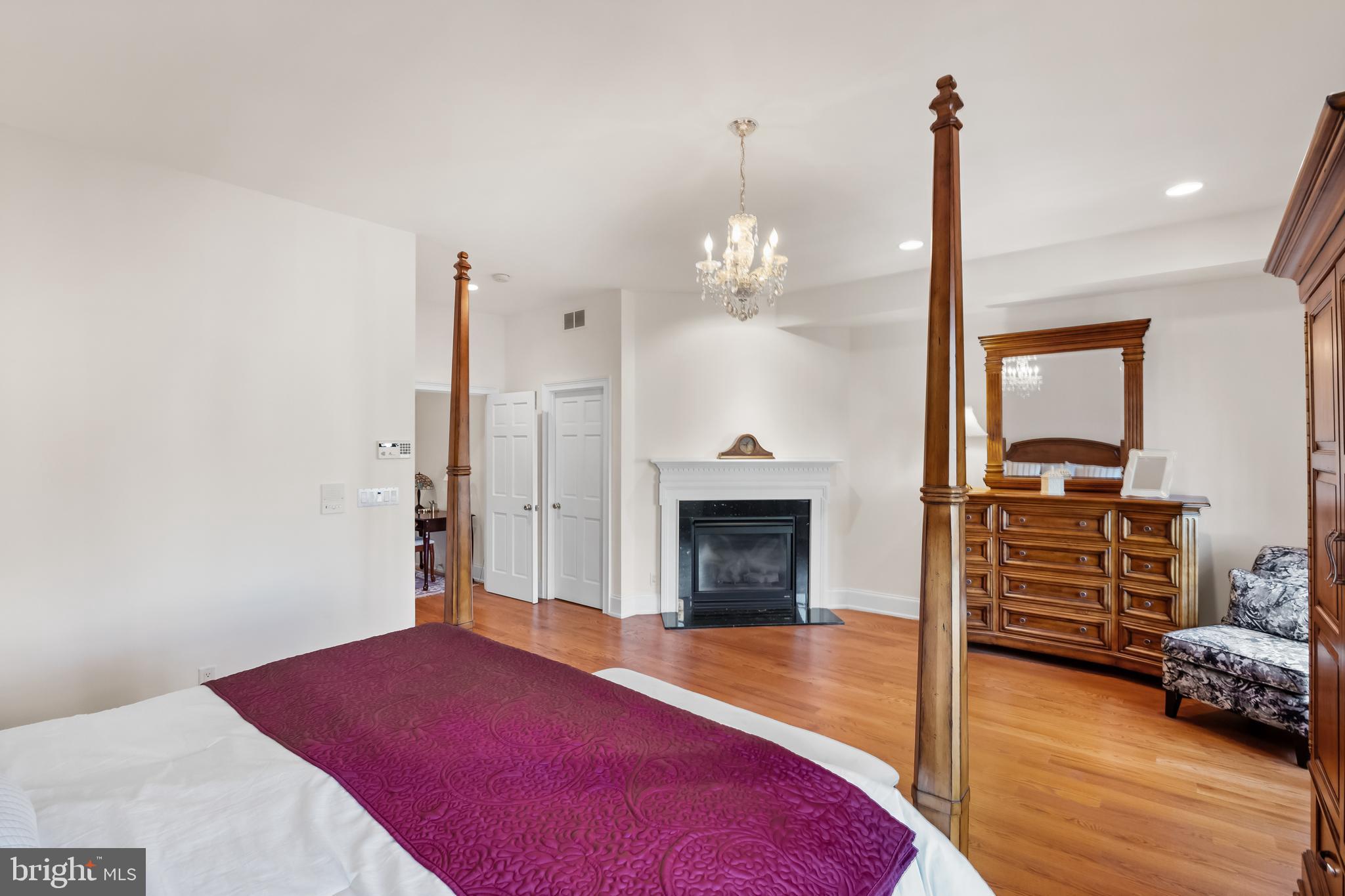 124 Bainbridge Street Philadelphia, PA 19147 - Photo 27 of 53 a spacious bedroom with a bed and a fireplace