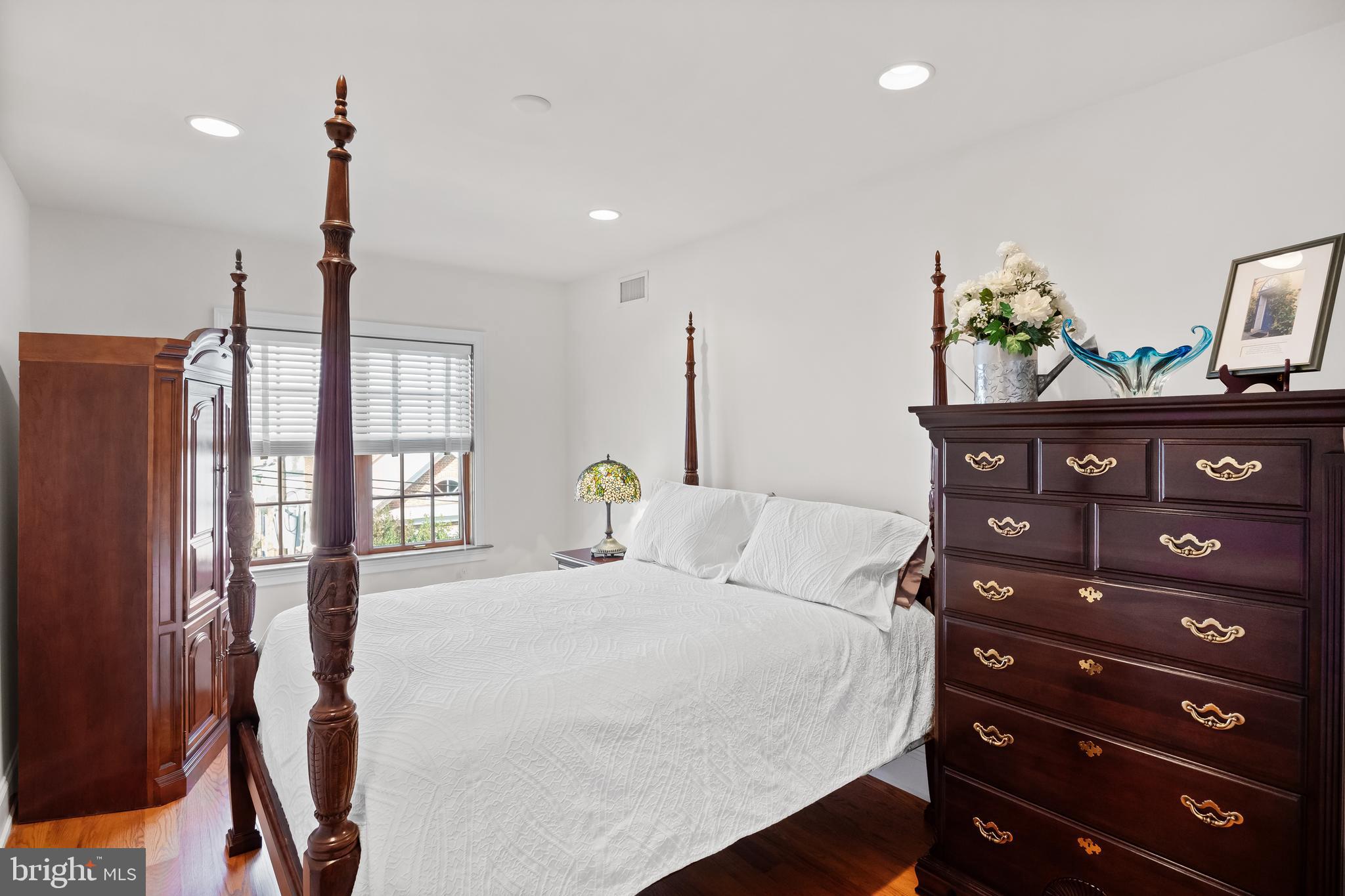 124 Bainbridge Street Philadelphia, PA 19147 - Photo 38 of 53 a bedroom with a bed a dresser and potted plants