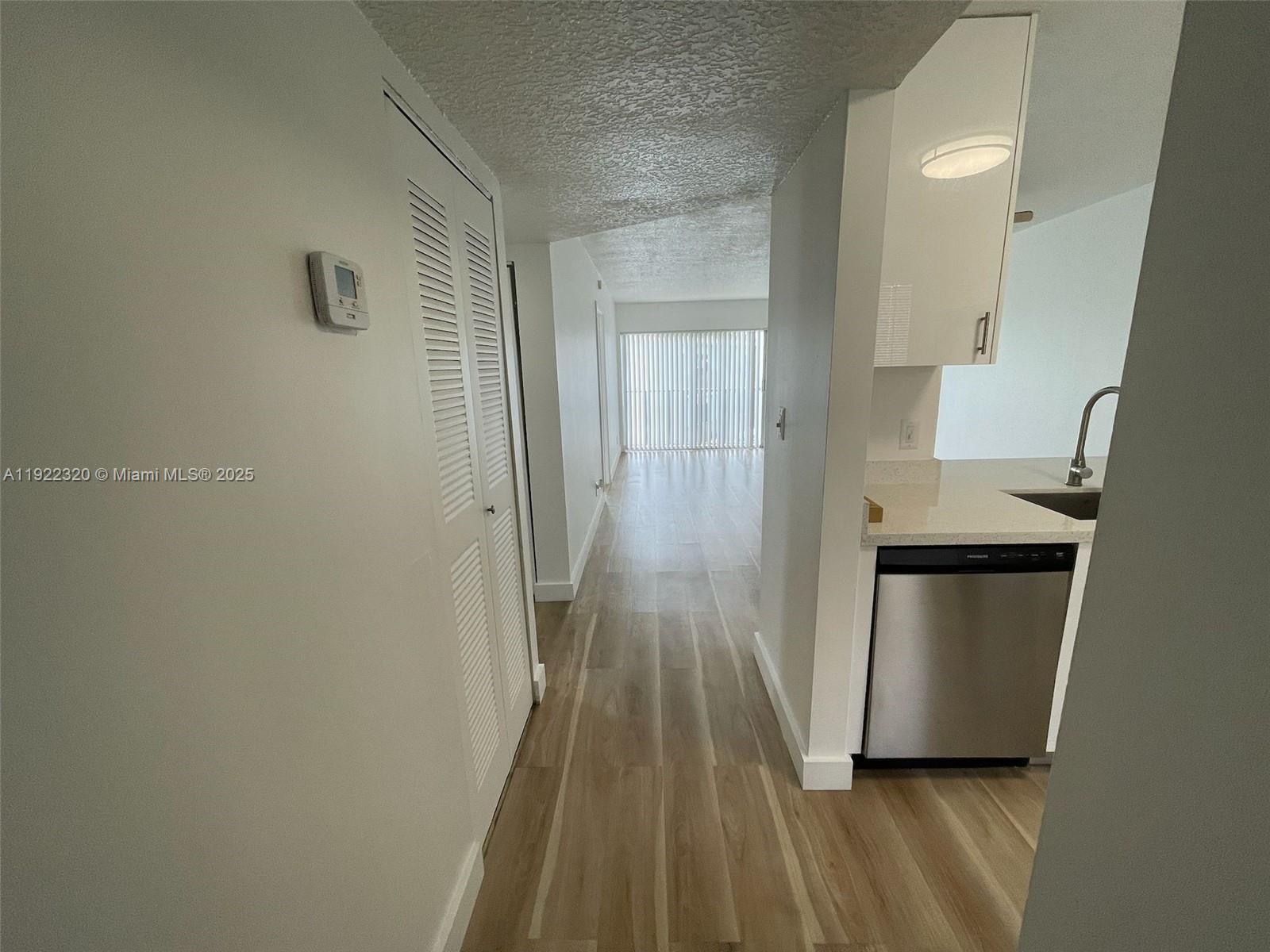 8700 Sherman Circle North, Unit 501 Miramar, FL 33025 - Photo 13 of 14 a view of a hallway with wooden floor and staircase
