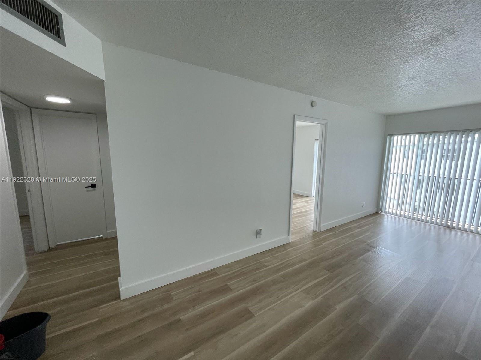 8700 Sherman Circle North, Unit 501 Miramar, FL 33025 - Photo 14 of 14 wooden floor in an empty room with a window
