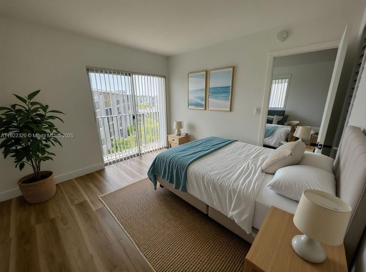8700 Sherman Circle North, Unit 501 Miramar, FL 33025 - Photo 3 of 14 a bedroom with a large bed and a potted plant