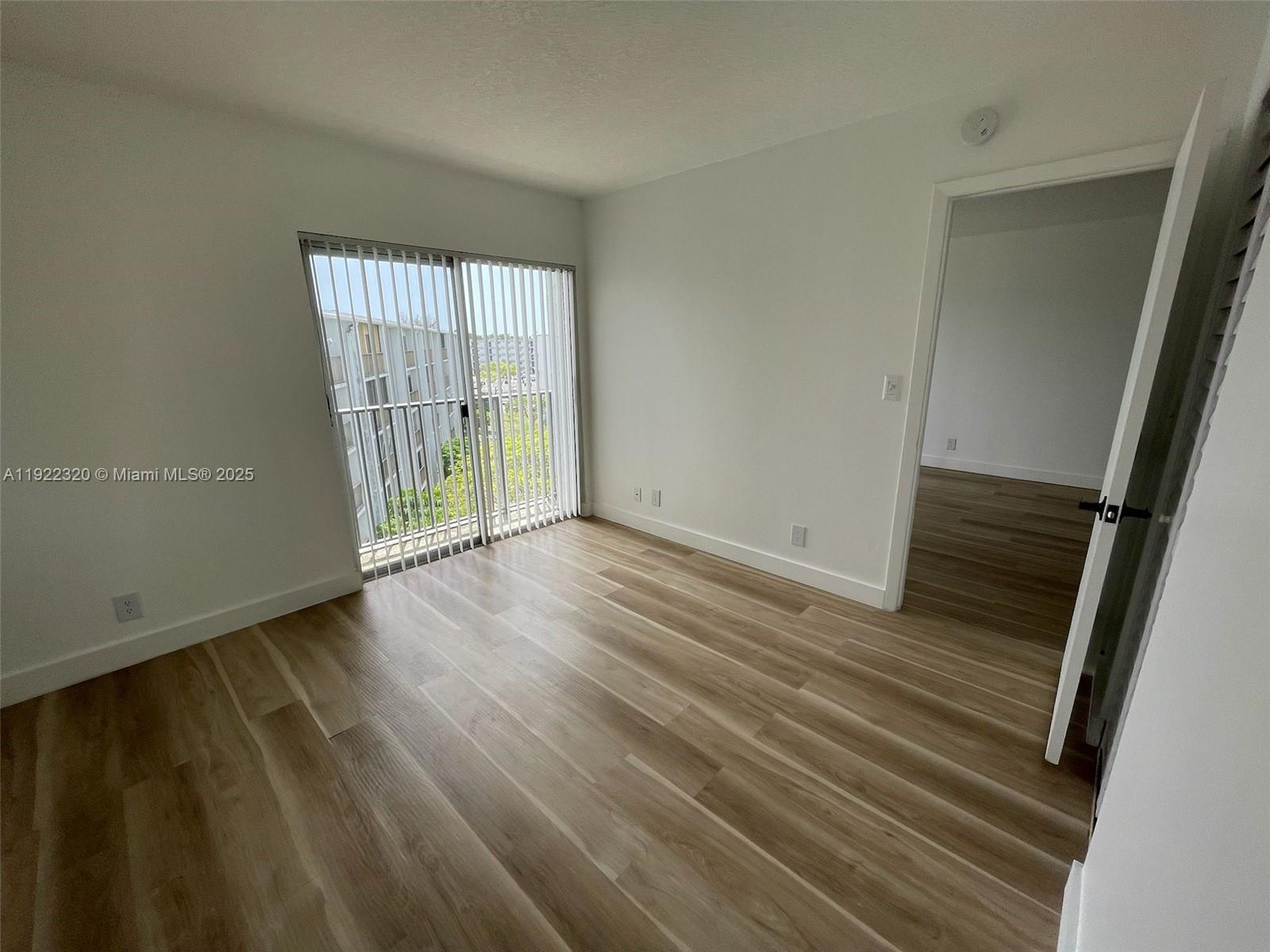 8700 Sherman Circle North, Unit 501 Miramar, FL 33025 - Photo 4 of 14 a view of wooden floor and windows in a room