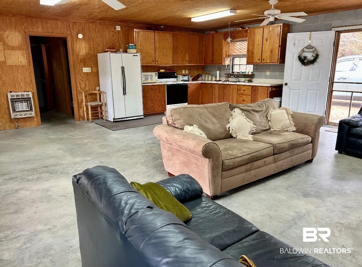 3881 Old Atmore Road Flomaton, AL 36441 - Photo 10 of 22 Living room featuring wood ceiling, heating unit, wood walls, and ceiling fan