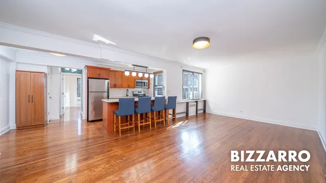 a view of a room with furniture and wooden floor