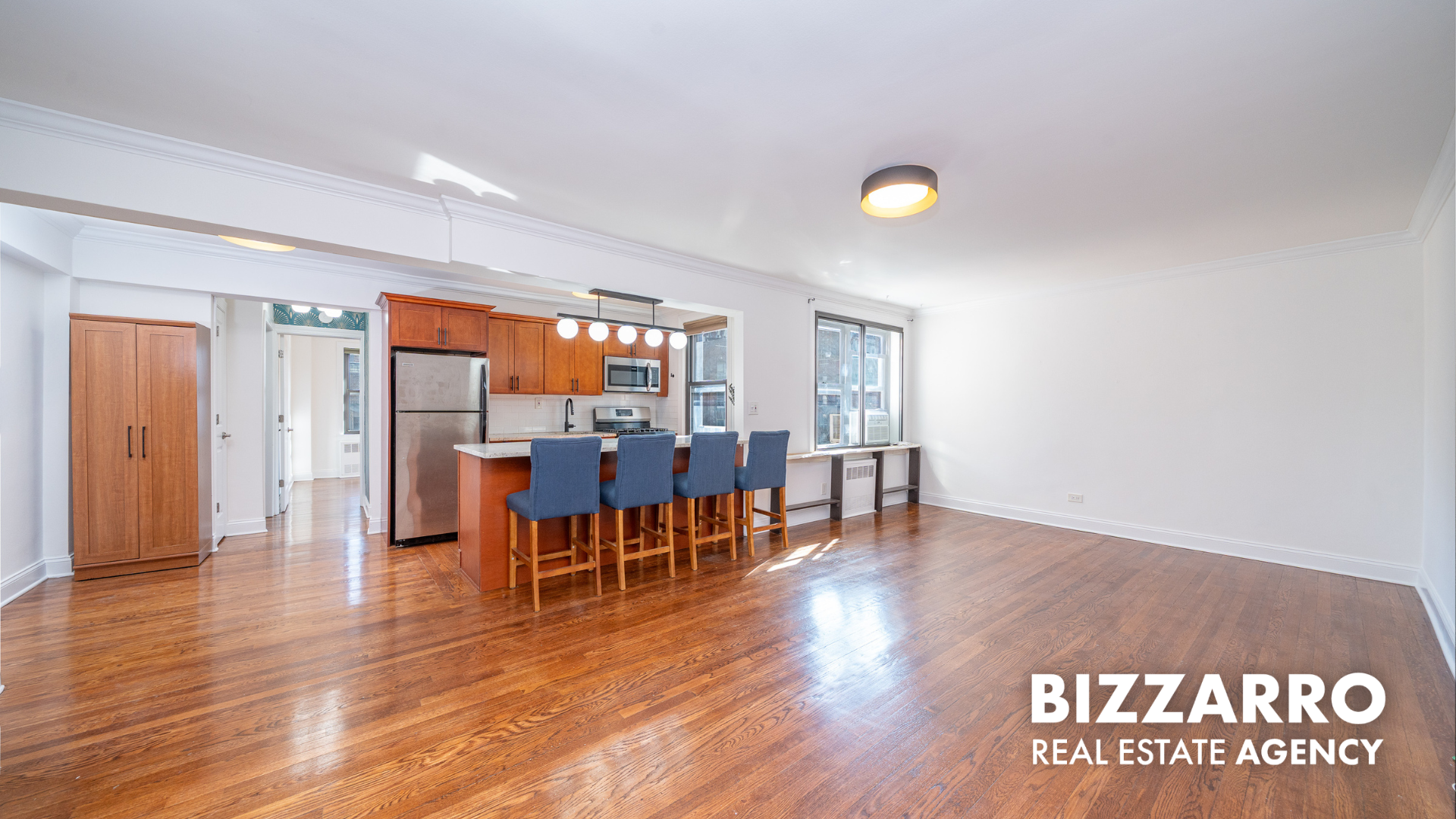 a view of a room with furniture and wooden floor