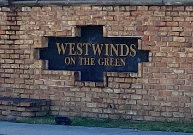 241 Wimbledon Lakes Drive, Unit 241 Plantation, FL 33324 - Photo 1 of 16 a sign on the brick wall