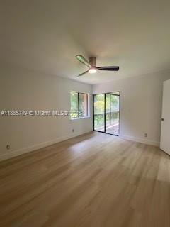 241 Wimbledon Lakes Drive, Unit 241 Plantation, FL 33324 - Photo 15 of 16 an empty room with windows and ceiling fan